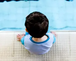 Pre-School Swimming Lessons (Child Sitting Poolside)