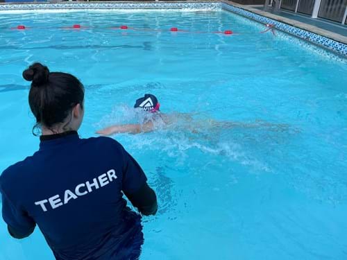 Teacher in water during swimming lessons